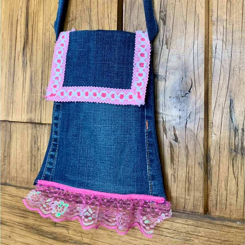 BoHo style dark denim purse with pink trim.